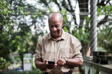 Senior man using smartphone outdoors